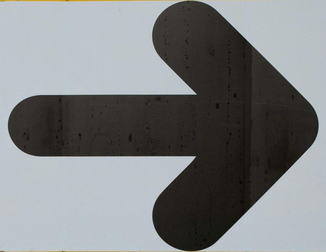 A bold black directional arrow on a bright yellow background, symbolizing movement.